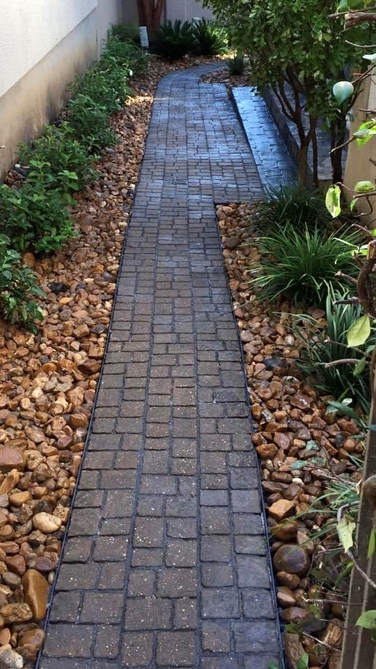 paver walkway with plants on the sides